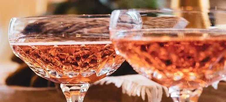 Two coupe glasses with rose wine