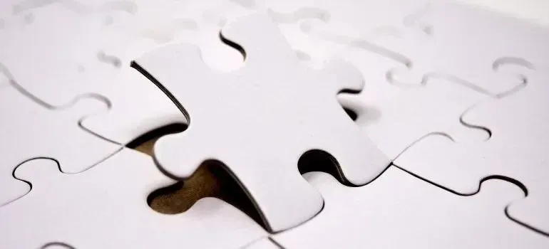 White jigsaw puzzle with one piece lifted out