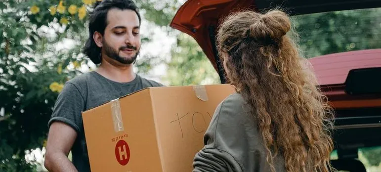 A mover carrying boxes into a New Jersey home