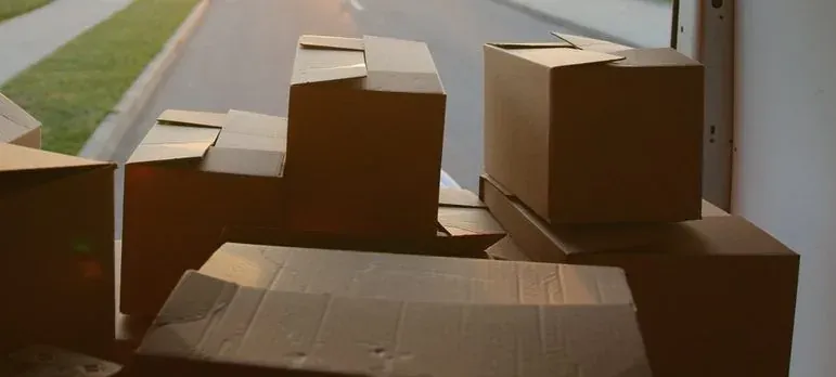 Friends carrying moving boxes into a new home in New Jersey
