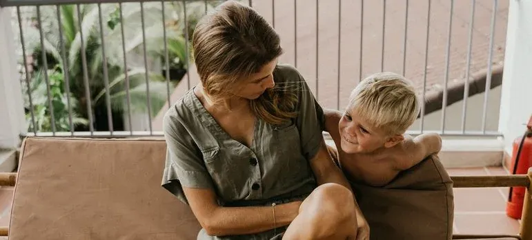 Mother and son on balcony bench