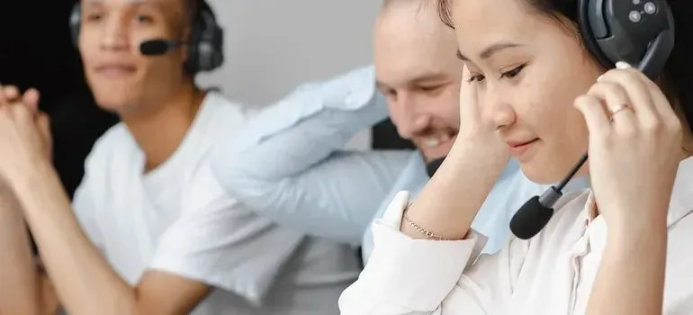 Three call center agents wearing headsets at work