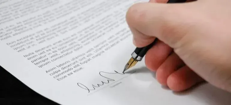 Hand signing document with fountain pen