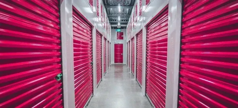Self-storage corridor with bright pink roll-up unit doors
