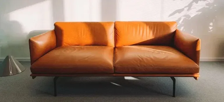 Cognac leather sofa in sunlit minimalist room