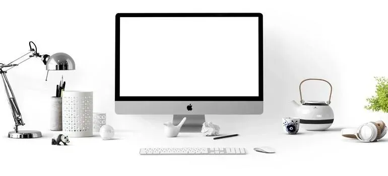 White desk with iMac and lamp