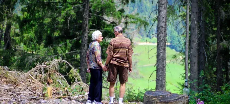 Elderly couple standing in forest