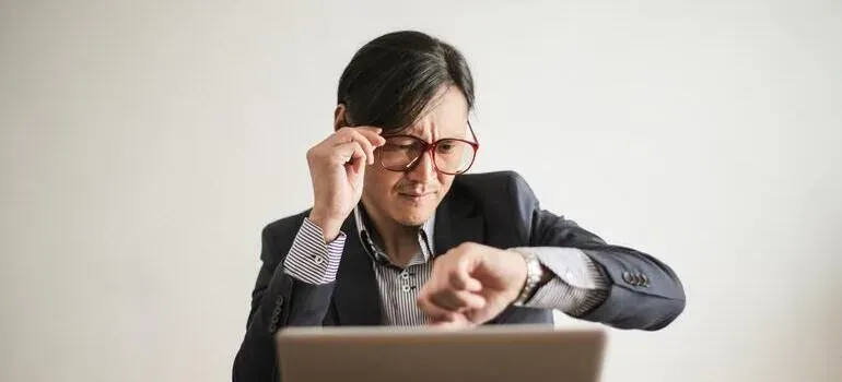 Man in suit checking wristwatch