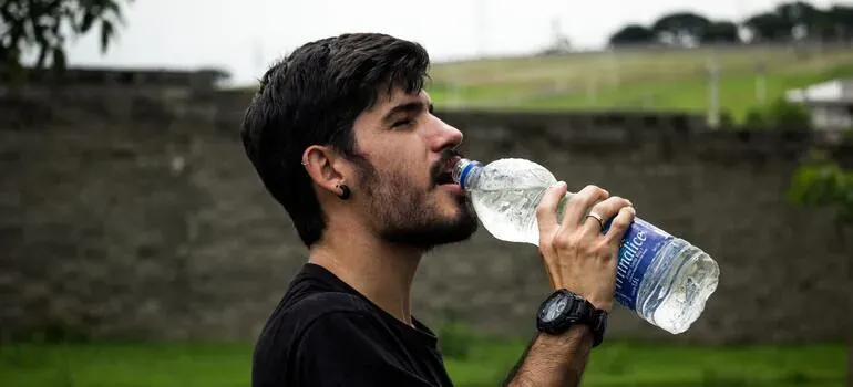 Man drinking bottled water outdoors
