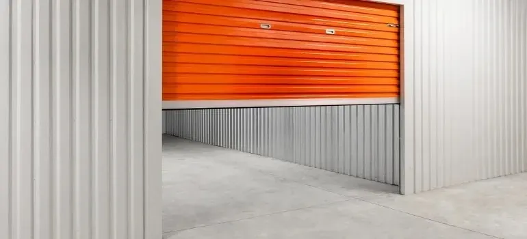 Empty self-storage unit with orange roller door