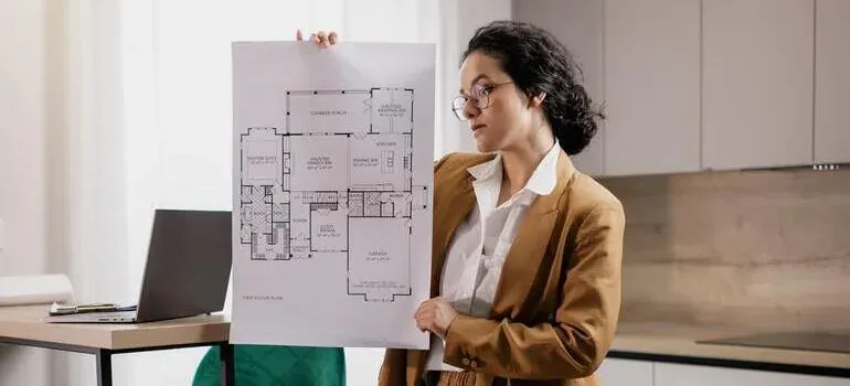 Woman holding house floor plan