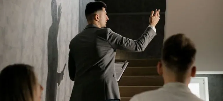 Man in suit presenting on stairs