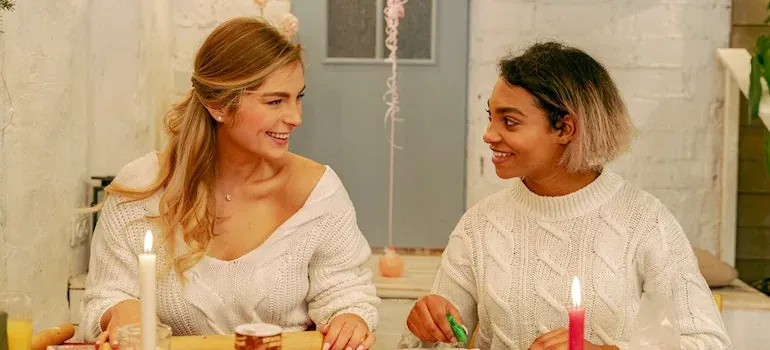 Two women crafting with candles