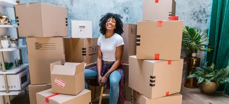 Smiling woman among moving boxes