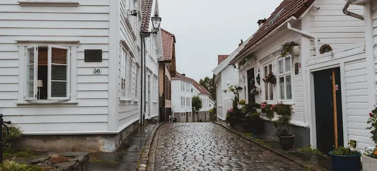 Cobblestone street with white houses