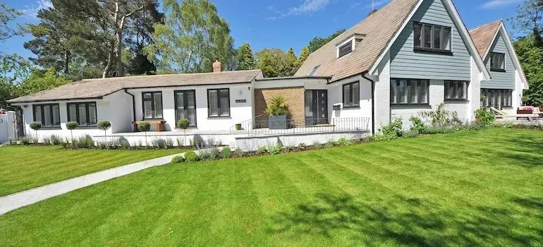 Modern gray and white house with manicured lawn