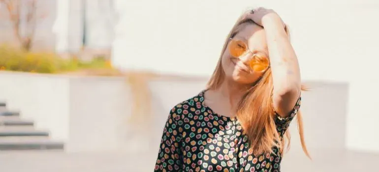 Smiling woman in sunglasses outdoors