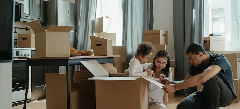 Family packing boxes in kitchen