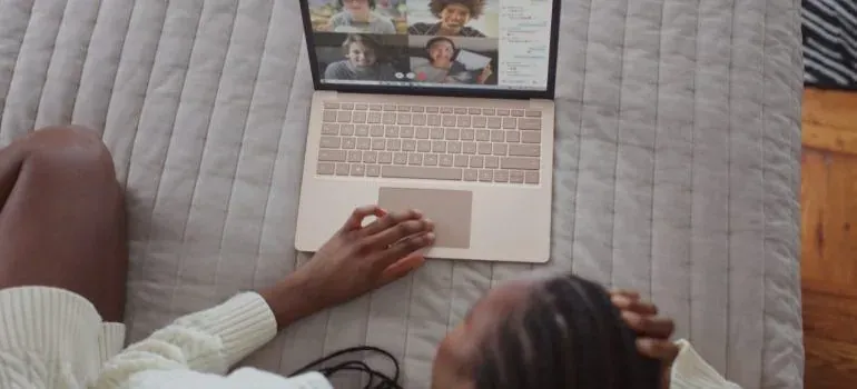 Woman on bed using laptop video call