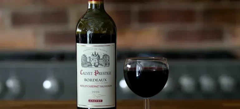 Calvet Bordeaux wine bottle and glass; product label only