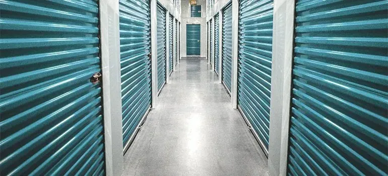Self-storage hallway with teal roll-up unit doors