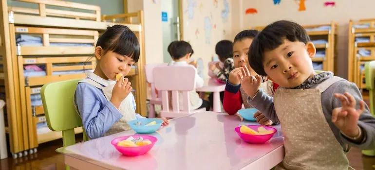 Children eating fruit in kindergarten