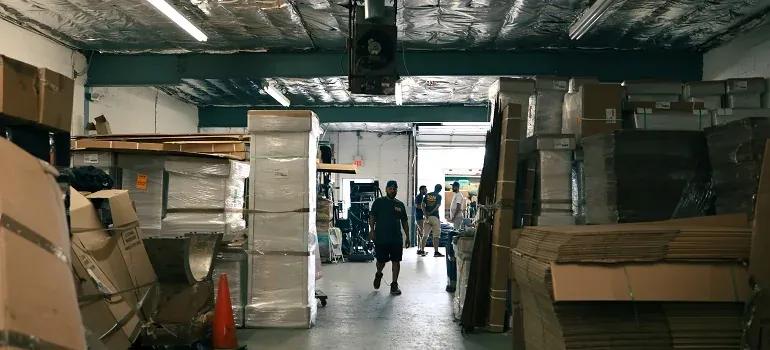 Young adult carrying moving boxes into a New Jersey apartment