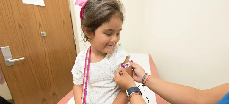 Child getting bandage at doctor office