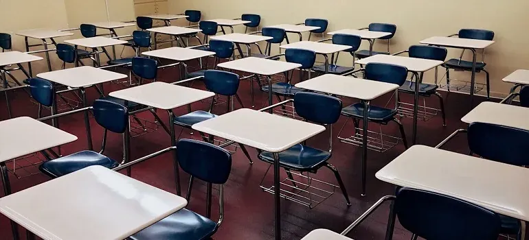 Empty classroom desks and chairs
