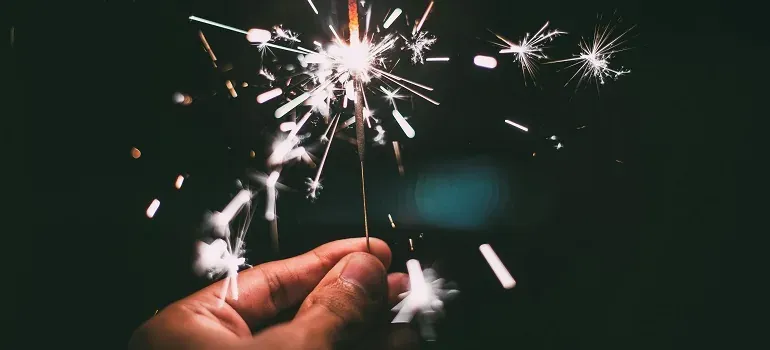 Hand holding a sparkler at night