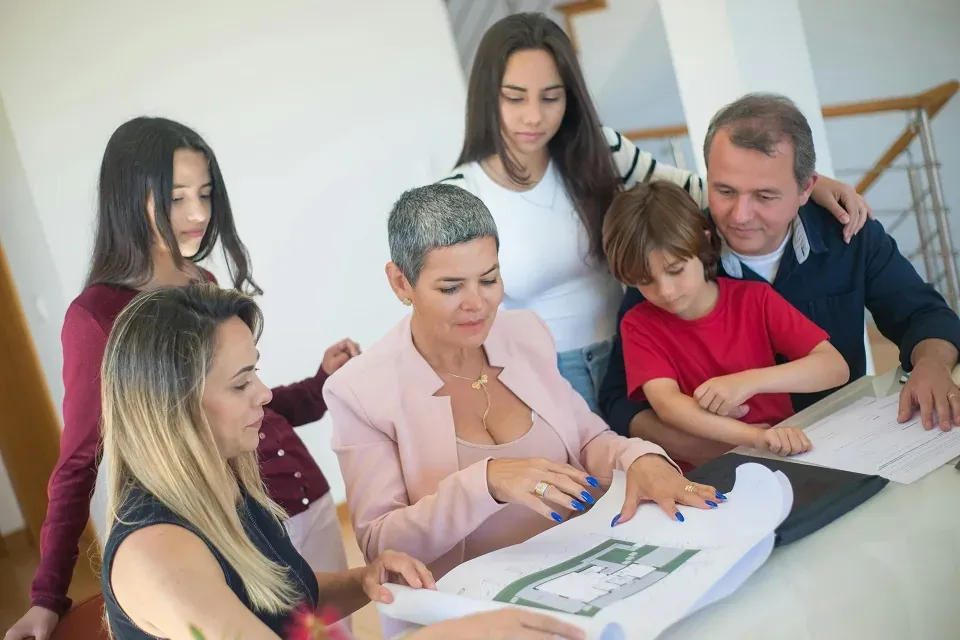 Family reviewing house blueprints together
