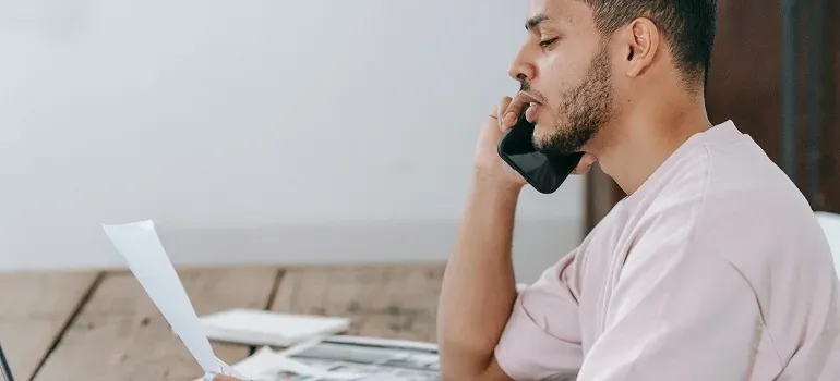 Man on phone reading document