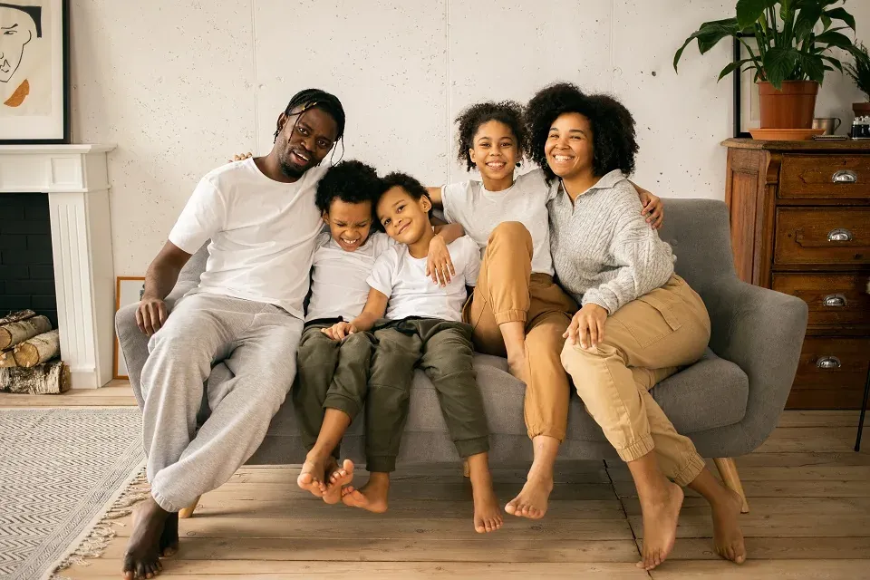 Family of five posing on sofa