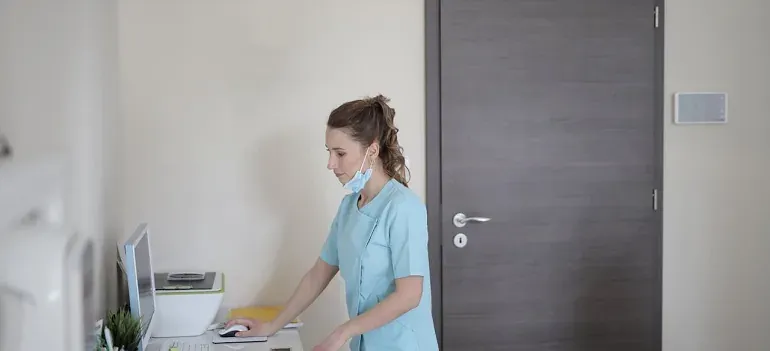 Nurse at computer in clinic