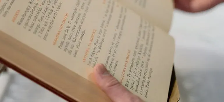 Open prayer book held in hands