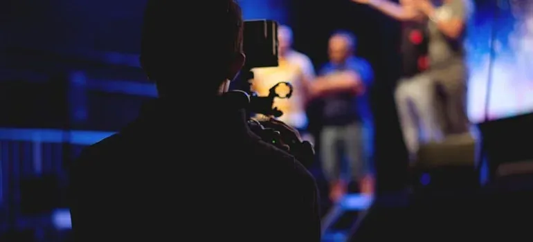 Videographer filming people on stage