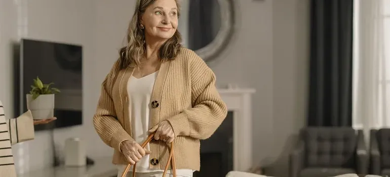 Older woman with bag in living room