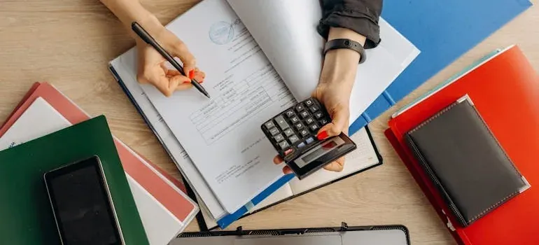 Hands with calculator over paperwork