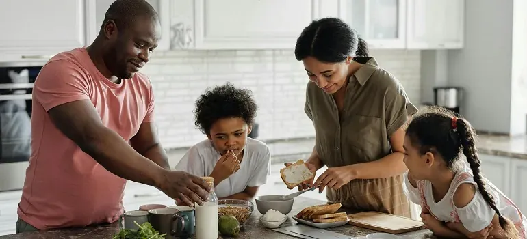 Family making breakfast in kitchen