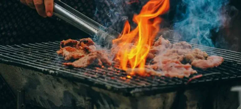 Meat grilling over open flame barbecue