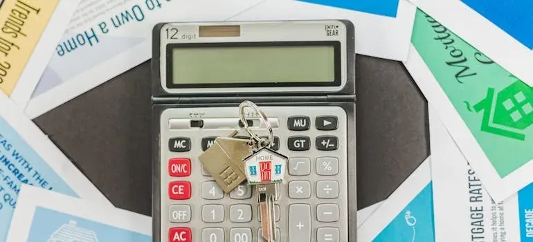 Calculator with house key on mortgage papers