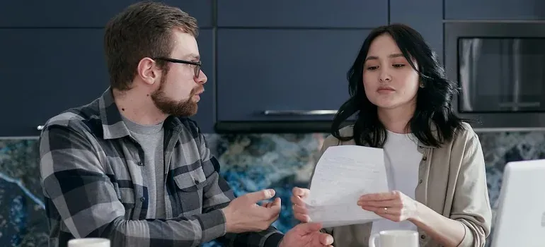 Couple reviewing document in kitchen