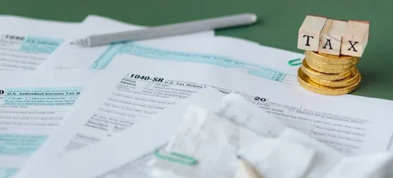 Tax forms, coins, TAX letter blocks