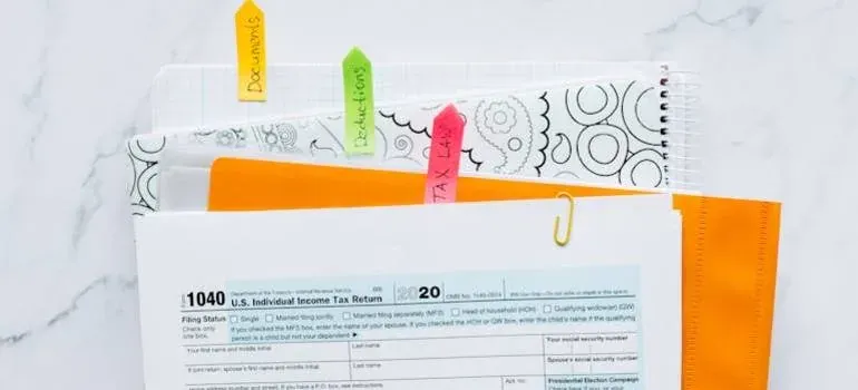 Tax form with tabbed notebook, envelope