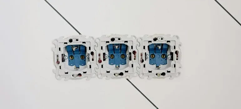 Three electrical outlet boxes on wall