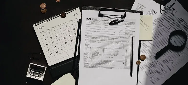 Tax form 1040 with calendar desk