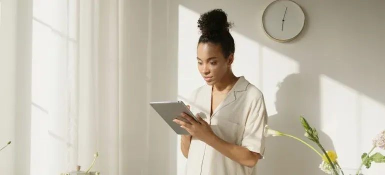 Woman using tablet in bright room