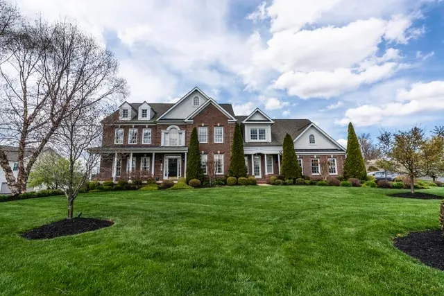 Large brick suburban house with lawn