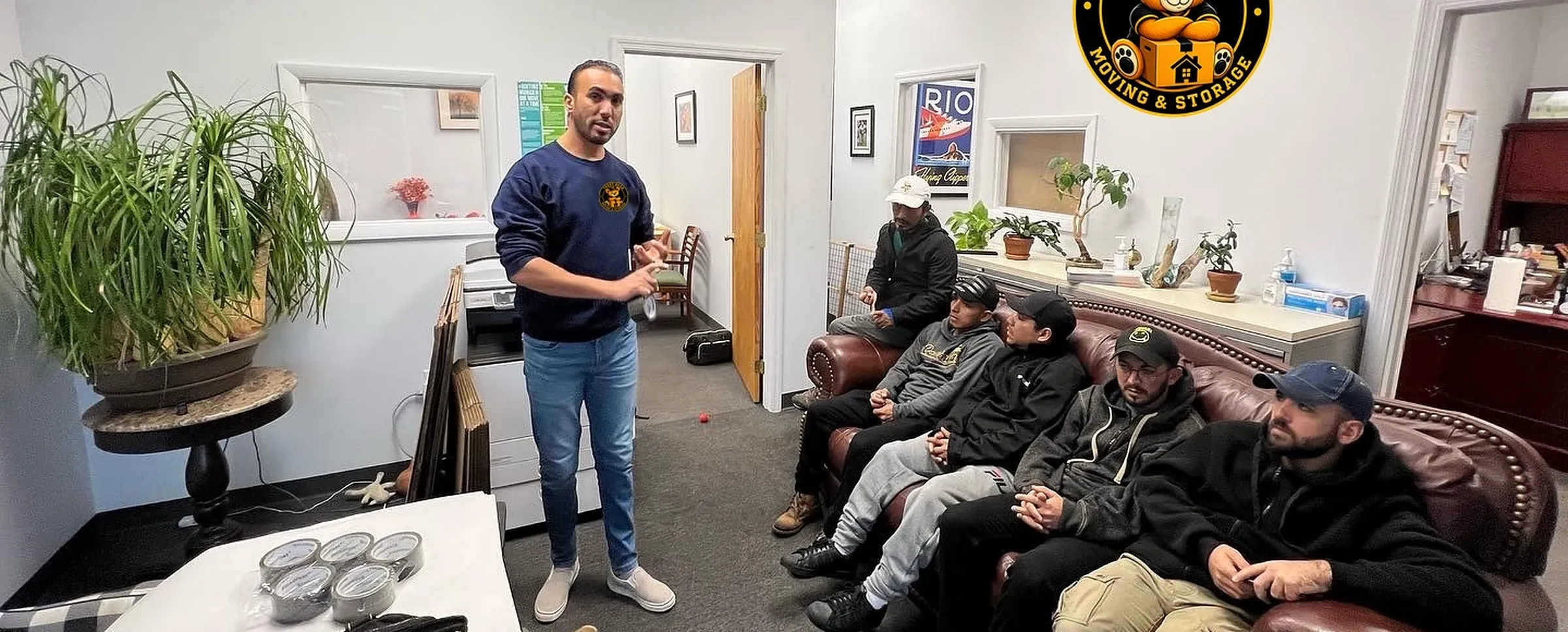 A Teddy Bear Moving manager briefing the crew in the company office