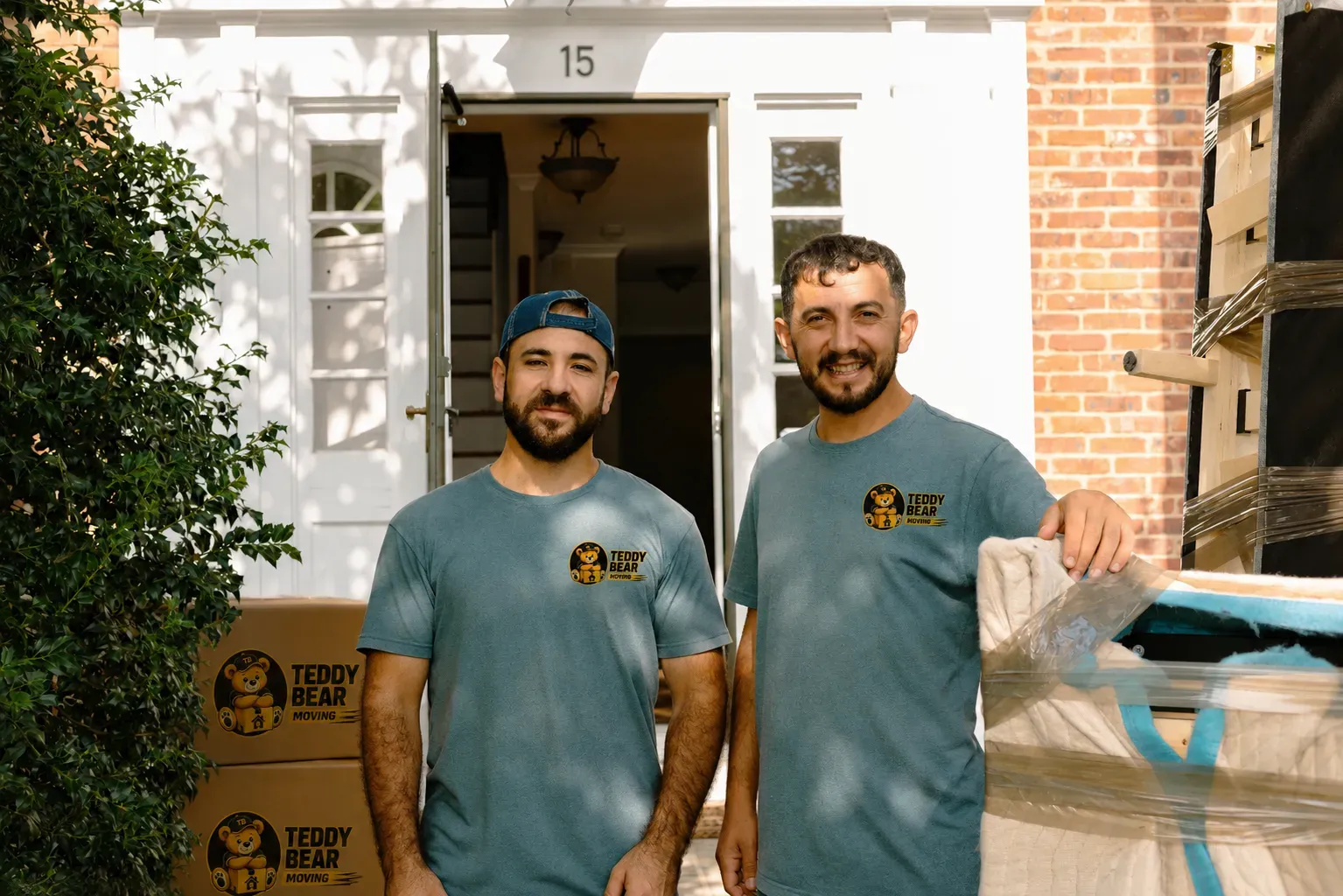 Teddy Bear Moving crew carrying furniture through a doorway